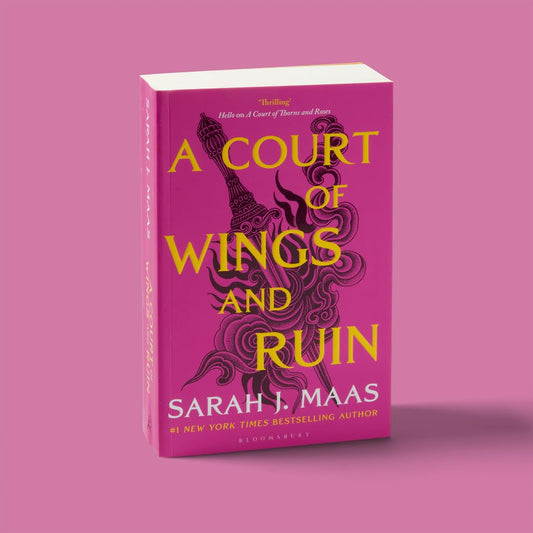 Book titled 'A Court of Wings and Ruin' by Sarah J. Maas on a pink background