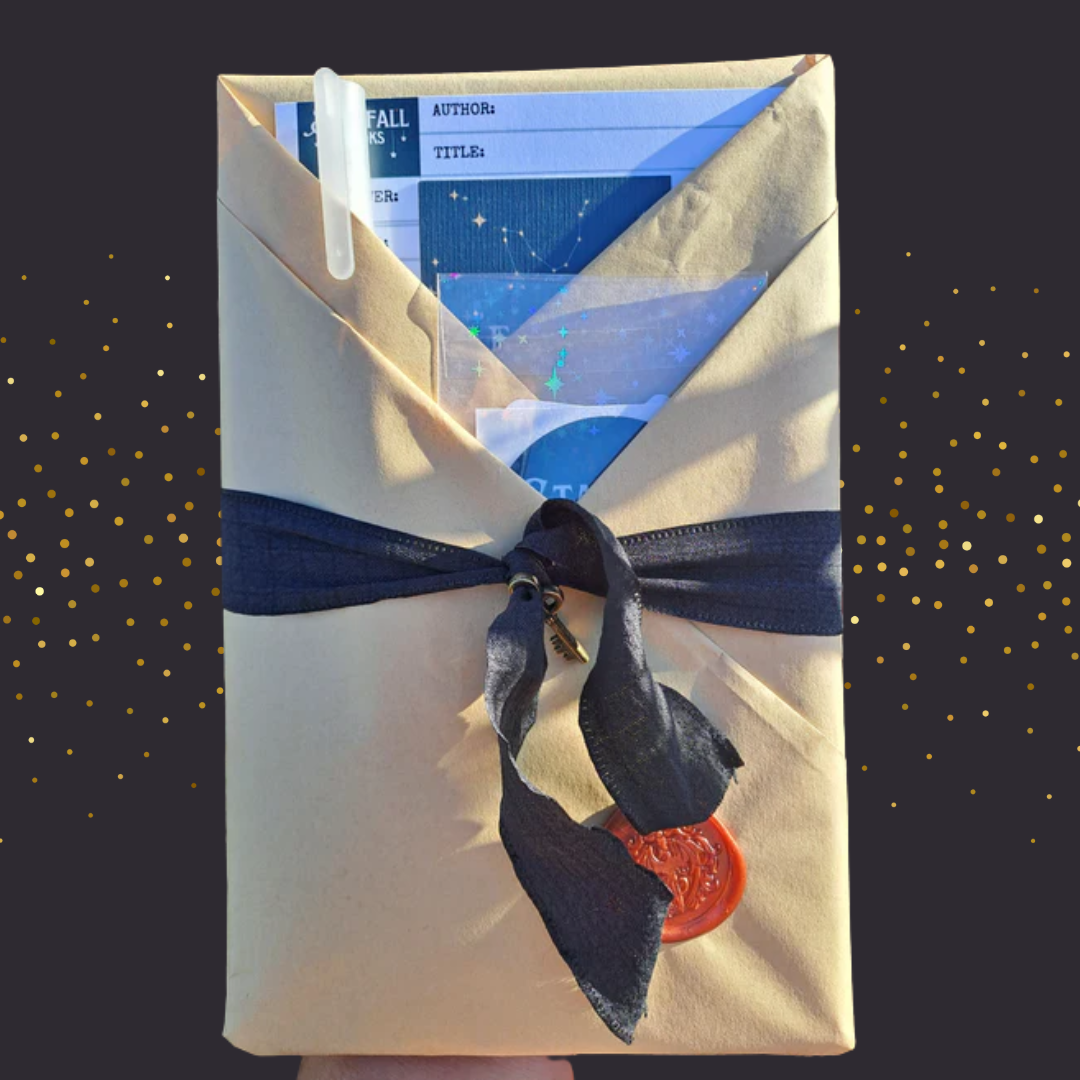 Book wrapped with a ribbon on a black glittery background