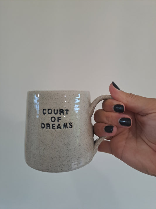 Court of Dreams mug being held in Steph's hand.
