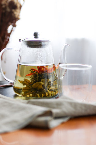 Blueberry Jam Blooming Tea shown in a clear glass teapot