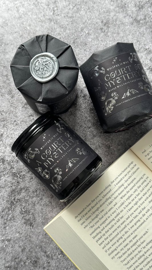 Court of Mystery candles show wrapped in black and unwrapped black jar.