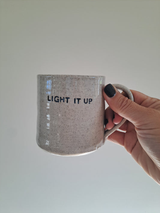 Light It Up Mug held by Steph.