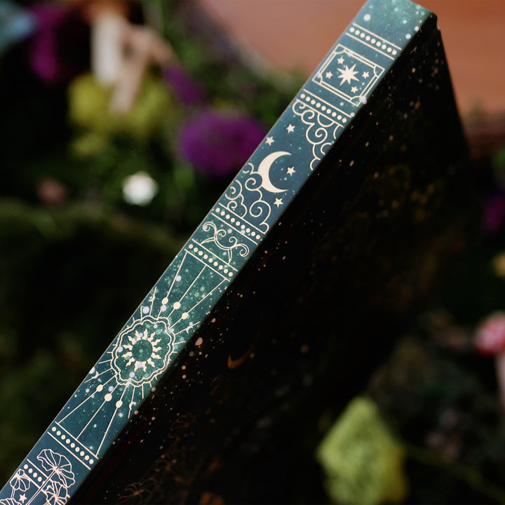 Dark green journal with intricate gold patterns, showing the spine.